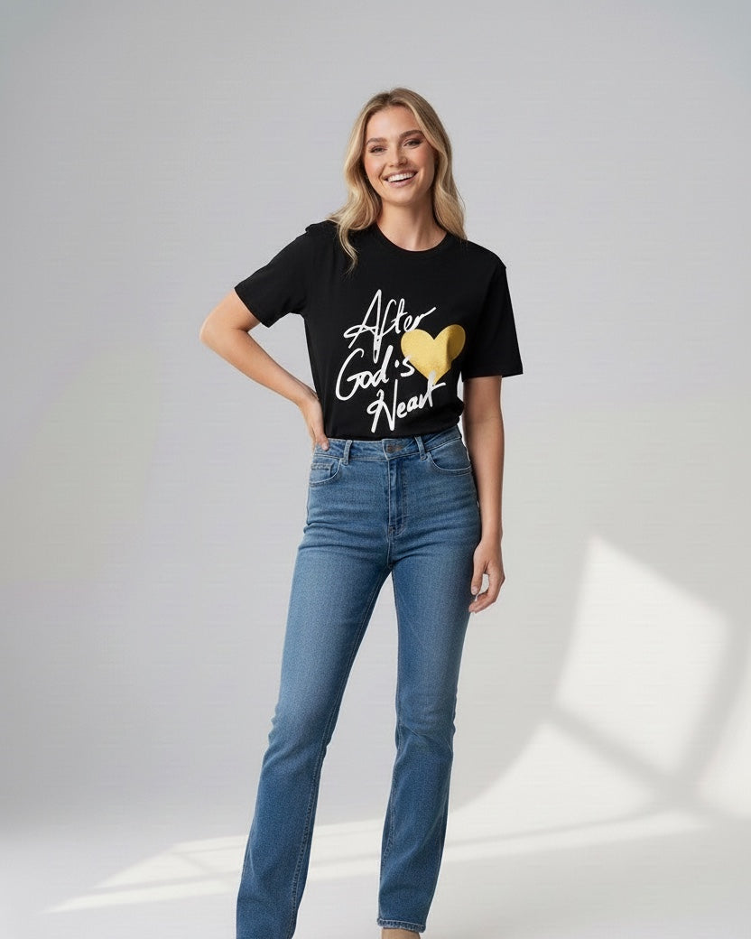 Woman wearing a black t-shirt with text and blue jeans on a white background