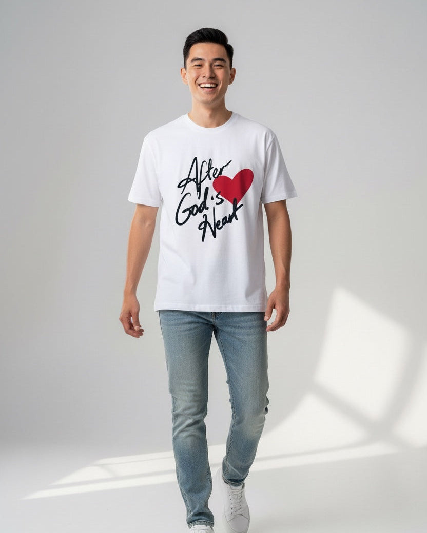 Man wearing a white t-shirt with text and a red heart graphic on a plain background