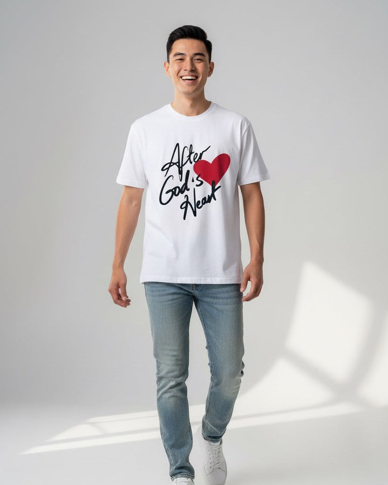 Man wearing a white t-shirt with text and a red heart graphic on a plain background