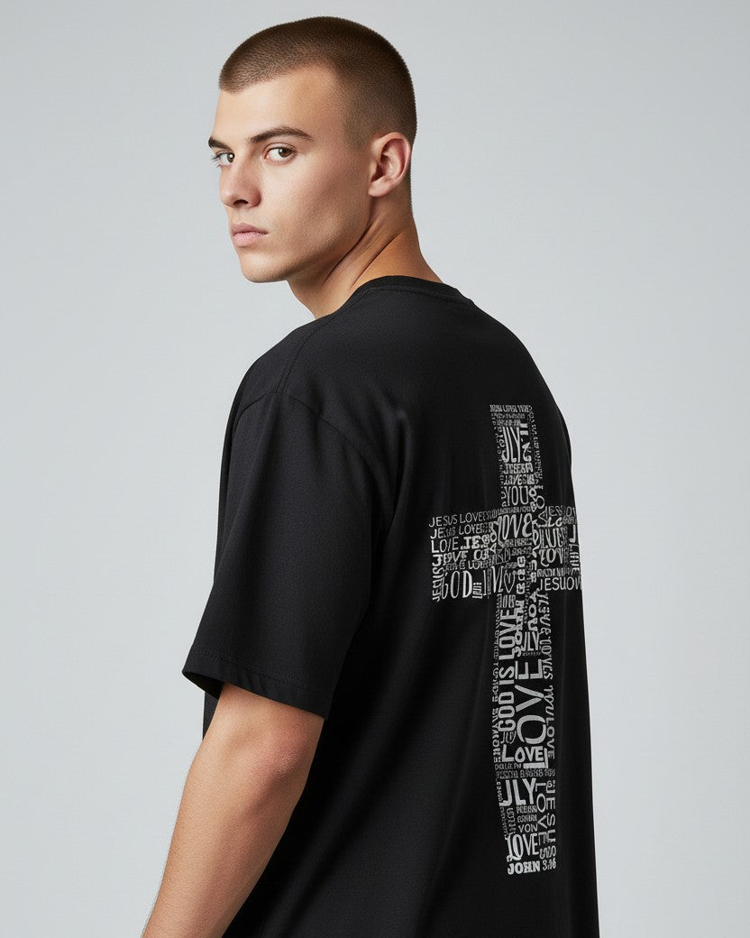 Man wearing a black t-shirt with text design on a plain background