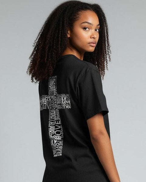 Person wearing a black t-shirt with text and blue jeans on a gray background