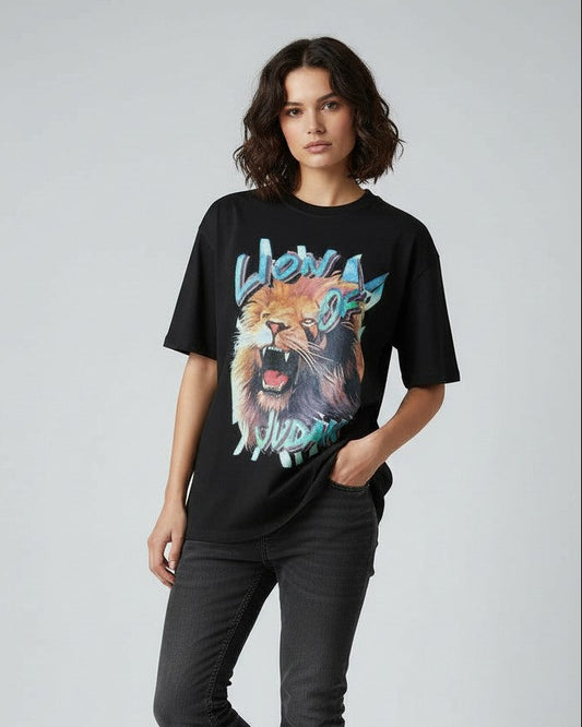 Person wearing a black christian t-shirt with a colorful lion graphic design on a plain background