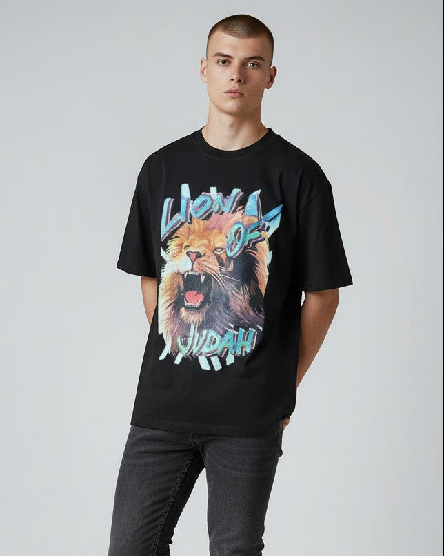 Person wearing a black christian t-shirt with a colorful graphic design on a plain background