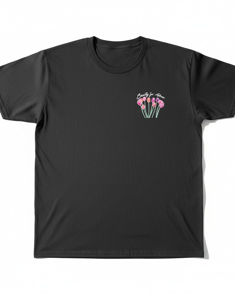 Black t-shirt with pink floral design on a white background
