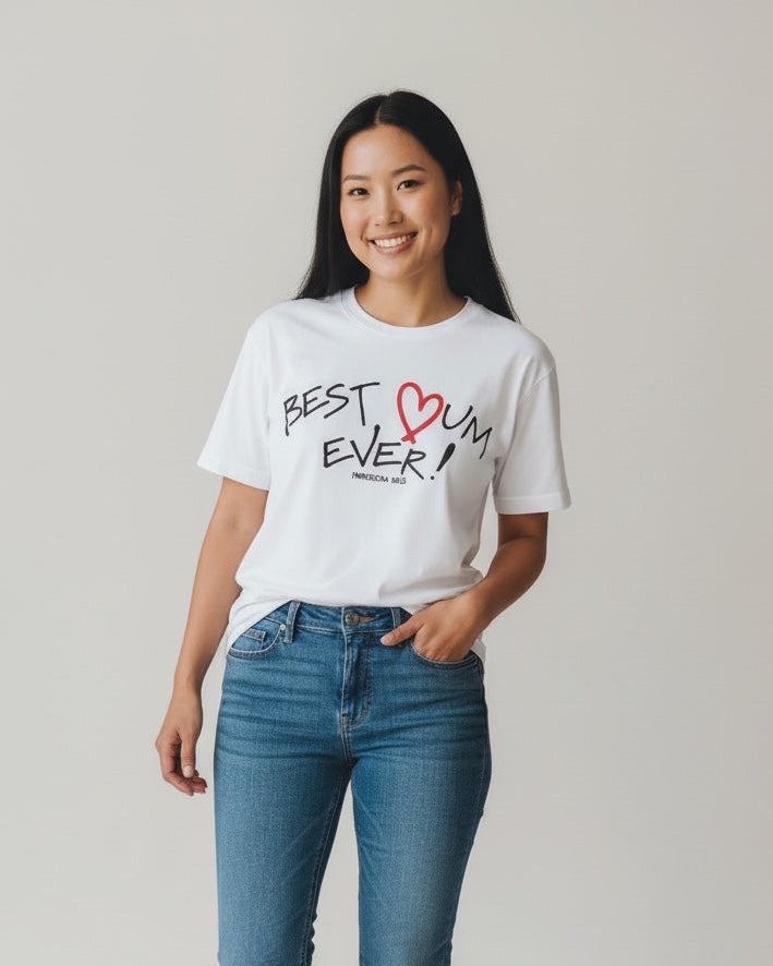 Woman wearing a white t-shirt with 'Best Mom Ever' text and blue jeans on a plain background