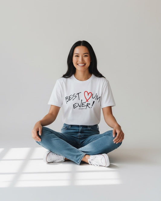 Person wearing a white t-shirt with 'Best Mum Ever!' text sitting on a light gray floor.
