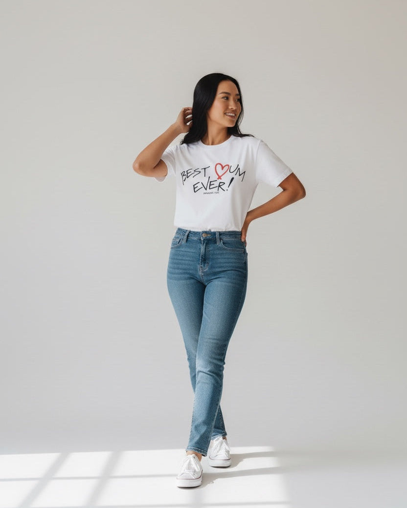 Person wearing a white t-shirt with text and blue jeans standing in a well-lit room.
