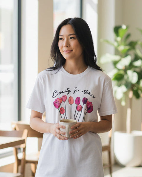 Woman wearing a christian white t-shirt with a graphic design in a modern cafe.