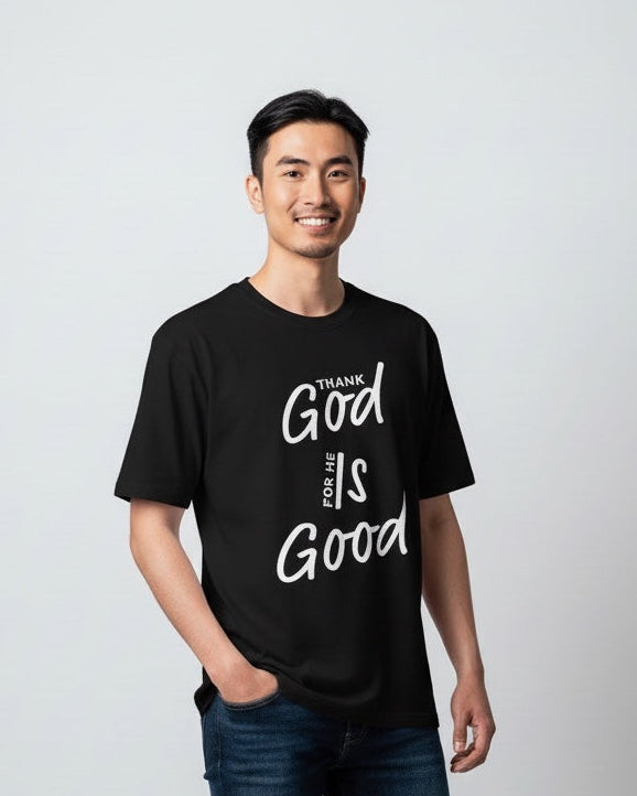 Man wearing a black t-shirt with 'Thank God the World is Good' text on a white background
