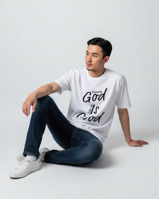 Man wearing a white t-shirt with text sitting on a white background