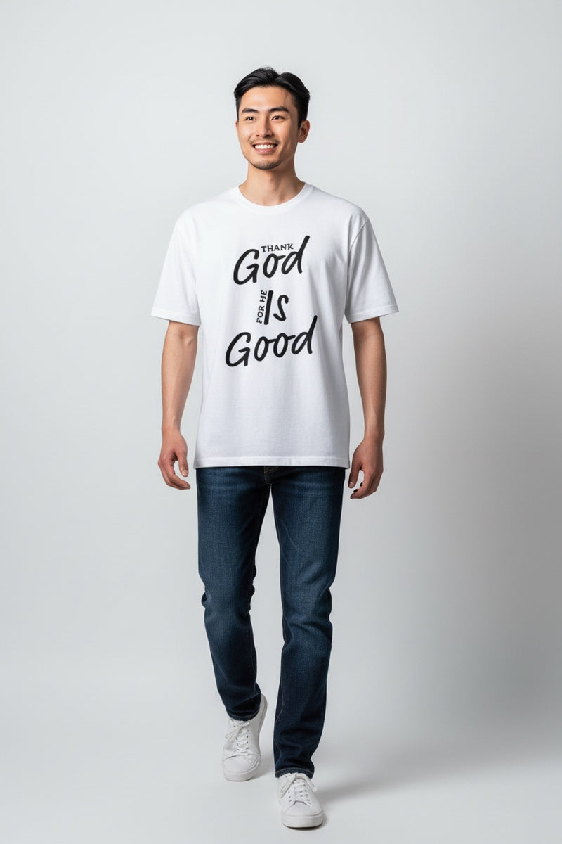Man wearing a white t-shirt with 'Thank God is Good' text on a plain background