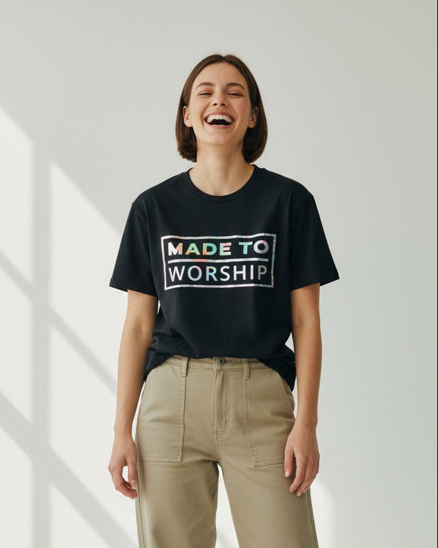 Person wearing a black t-shirt with 'Made to Worship' text on a white background