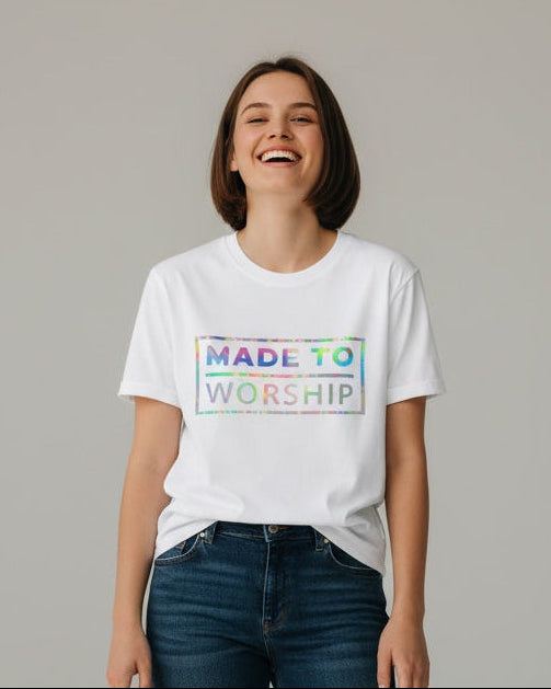 Person wearing a white t-shirt with colorful text and blue jeans on a gray background