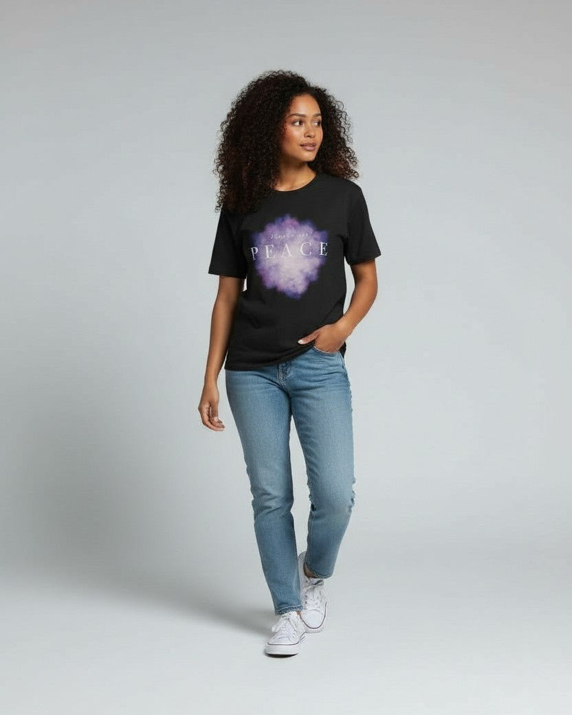 Woman wearing a black christian t-shirt with a purple graphic and text that says prince of peace, standing against a plain background