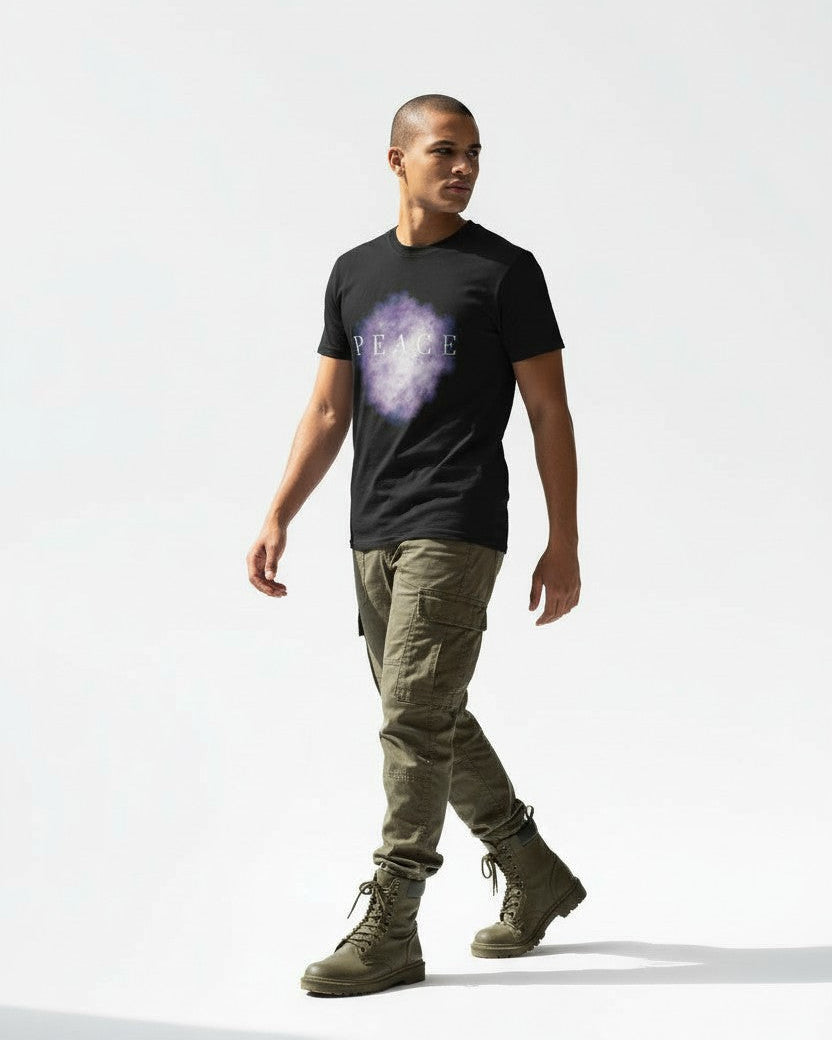 Man wearing a black christian t-shirt with a purple graphic design that says prince of peace, green pants, and green shoes on a white background