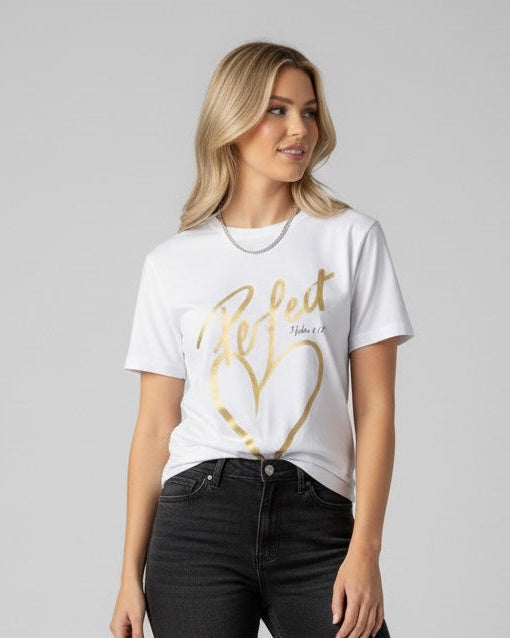 Woman wearing a white t-shirt with a gold heart design and black jeans on a gray background